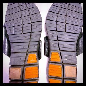 A pair of Cole Haan Leather Slippers